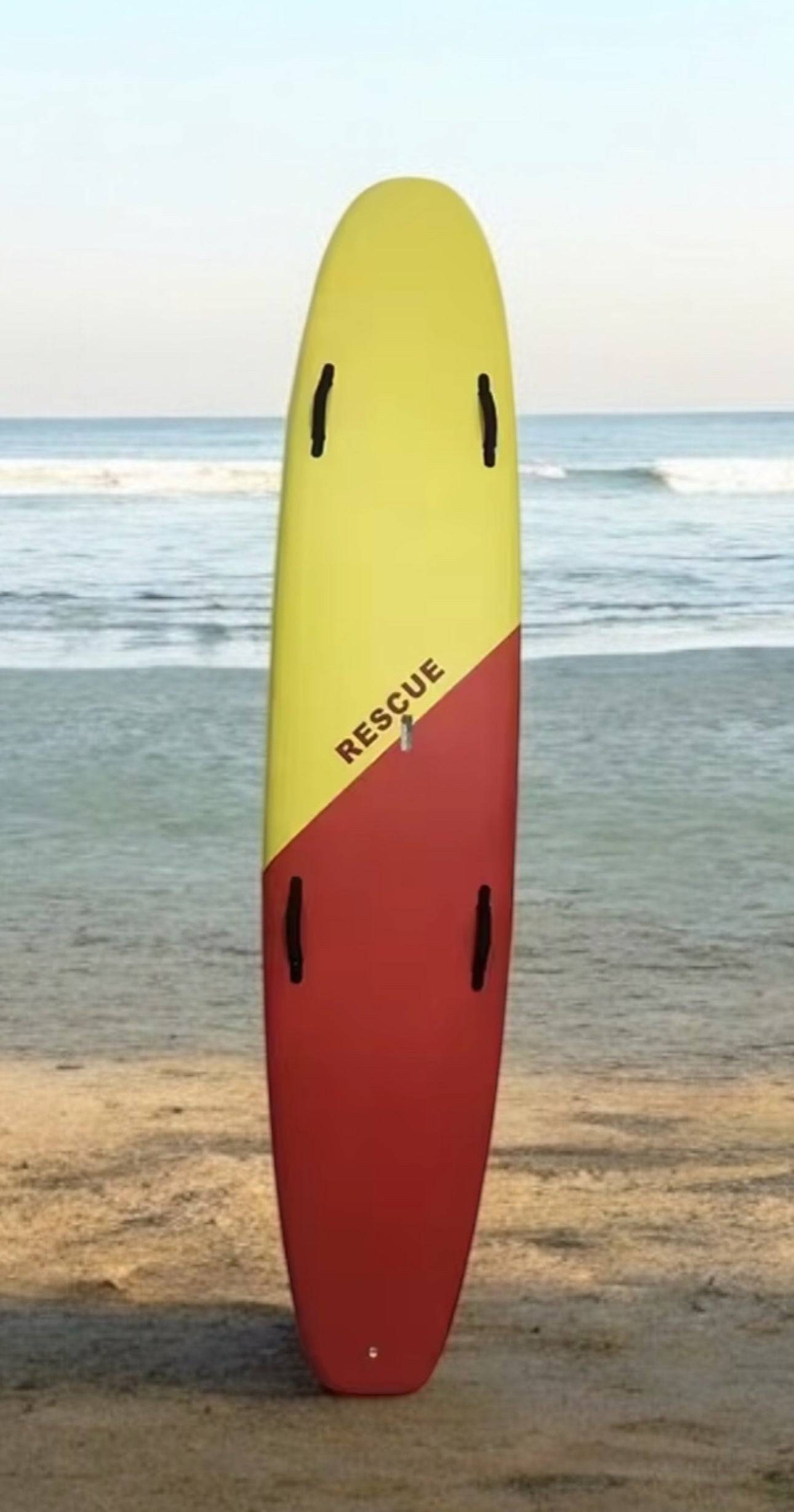 Rescue Board 10 ft - Durable & Safe | Performance-Driven in red and yellow with black handles, ideal for emergency water rescues on beaches.