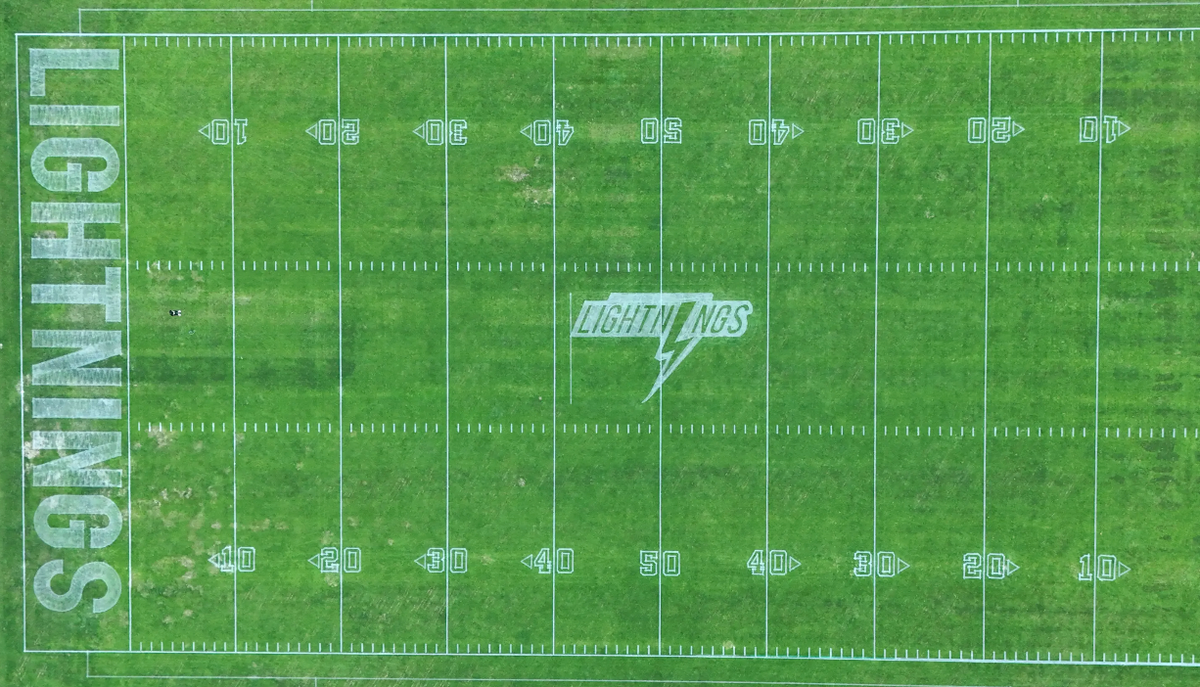 Aerial view of sports field with robotic lawn mower marking